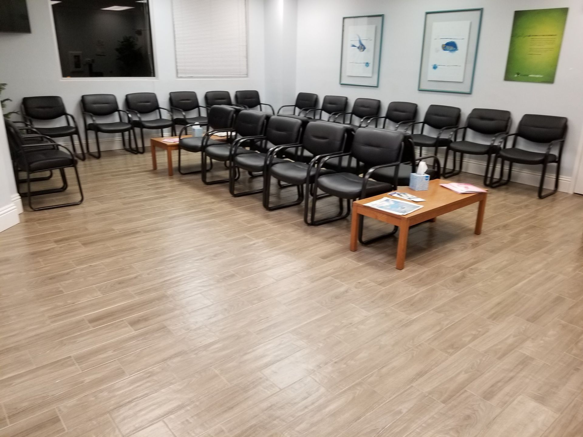 A waiting room with a lot of chairs and tables.