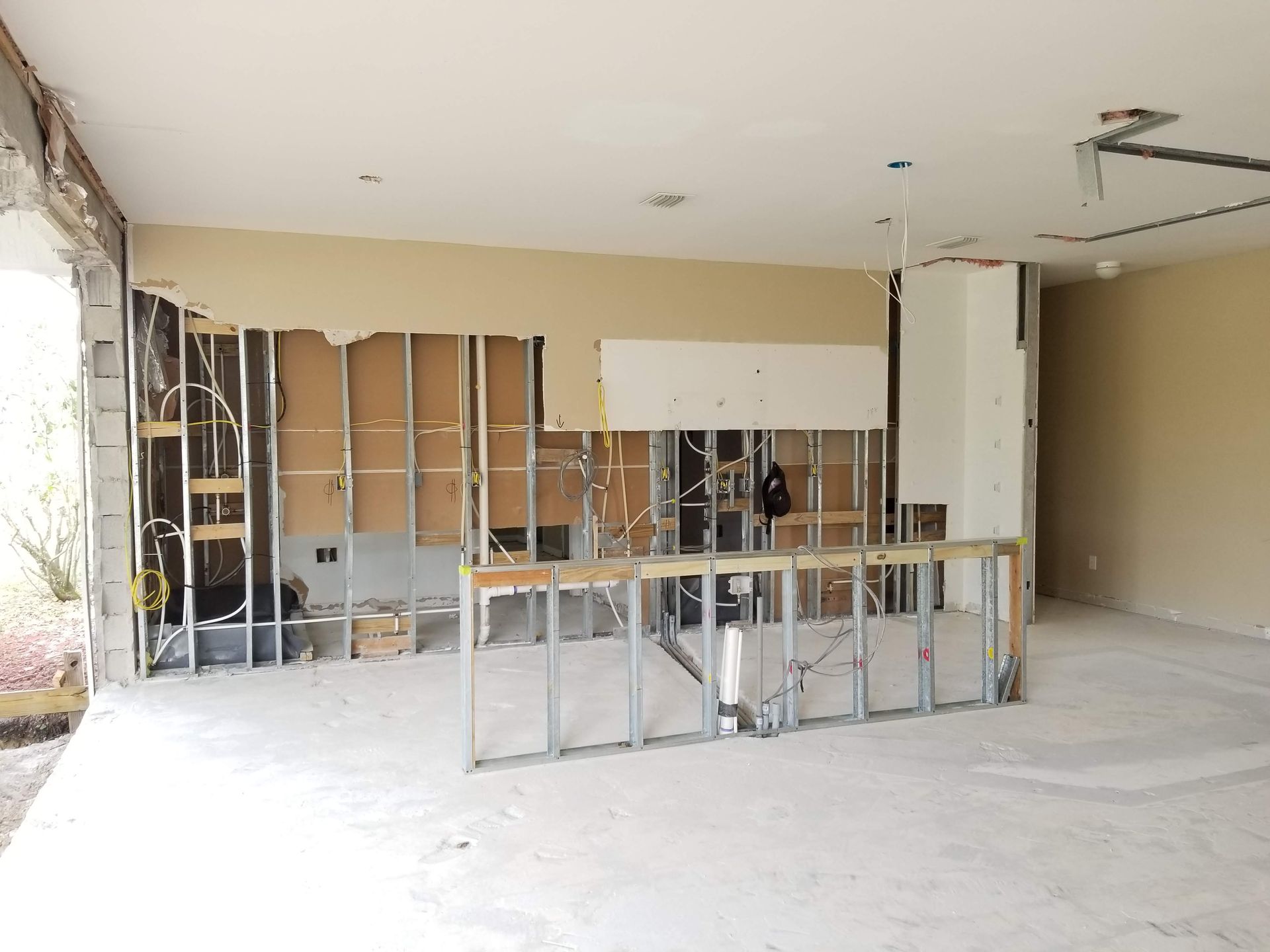A large empty room with a ladder in the middle of it.