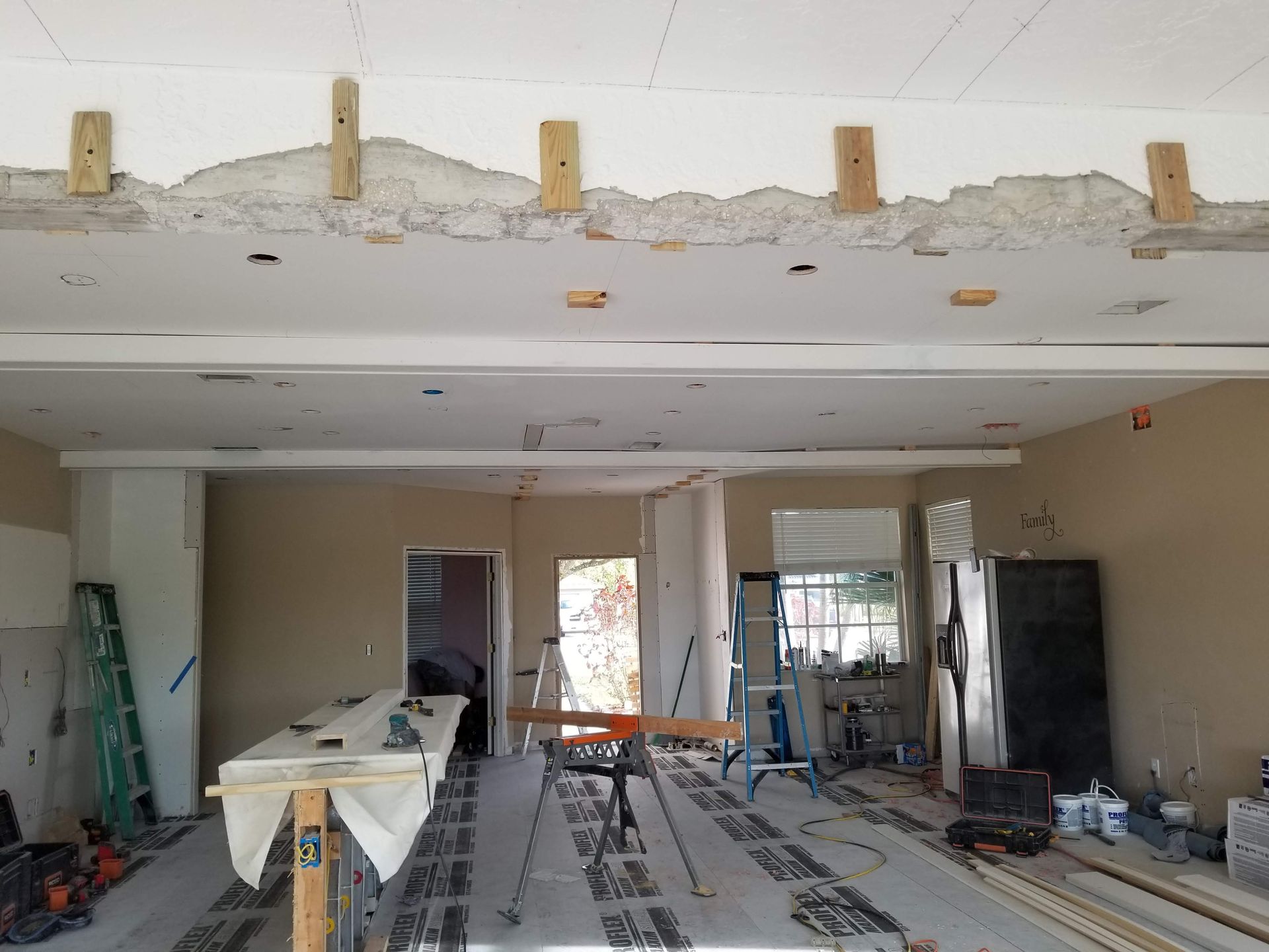A large room with a ceiling that is being remodeled