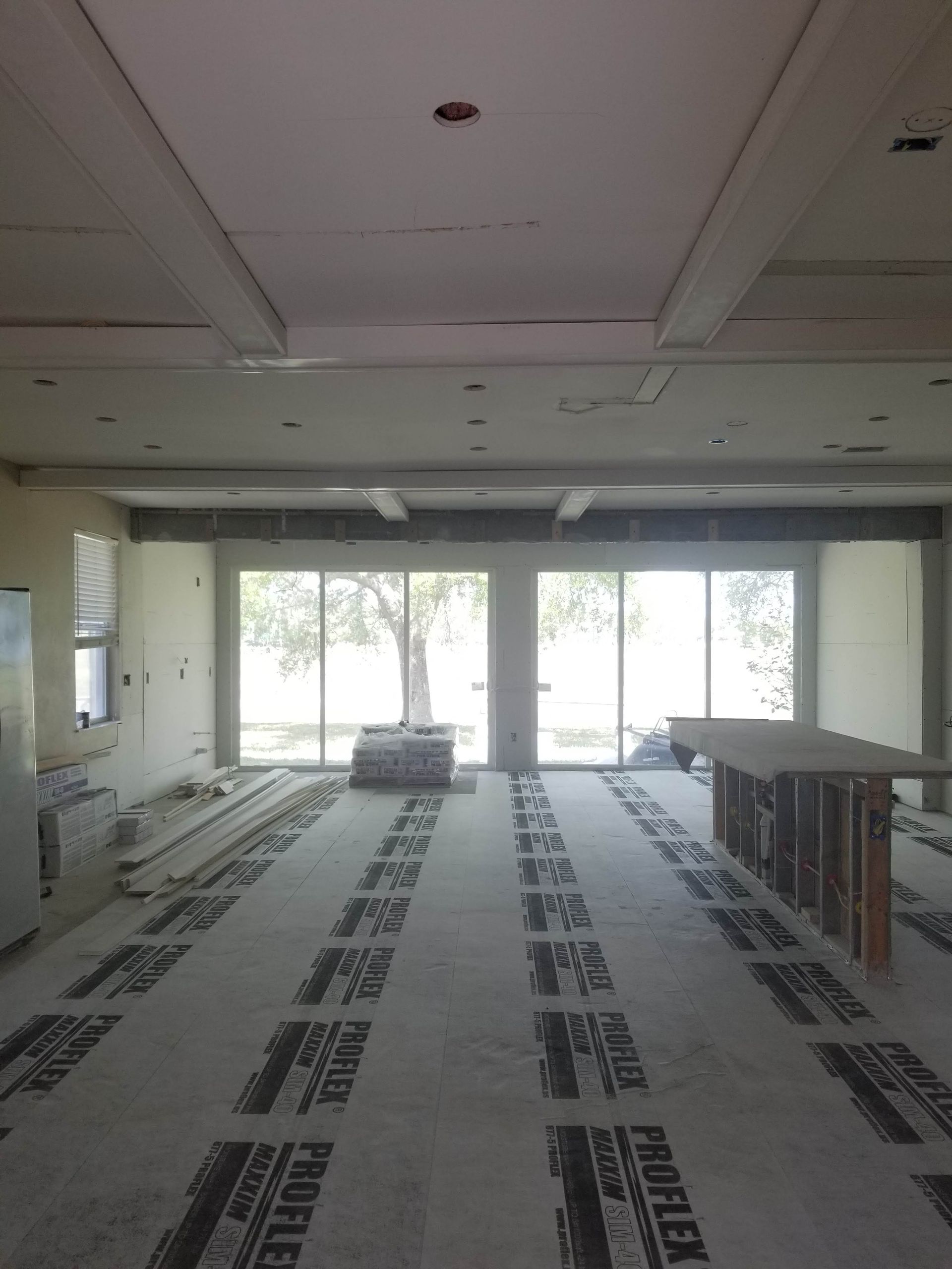 A large room with a lot of windows and a carpet covering the floor.