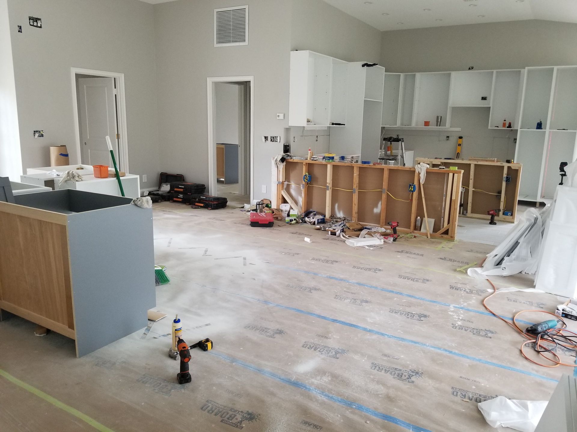 A kitchen under construction with a lot of tools on the floor.