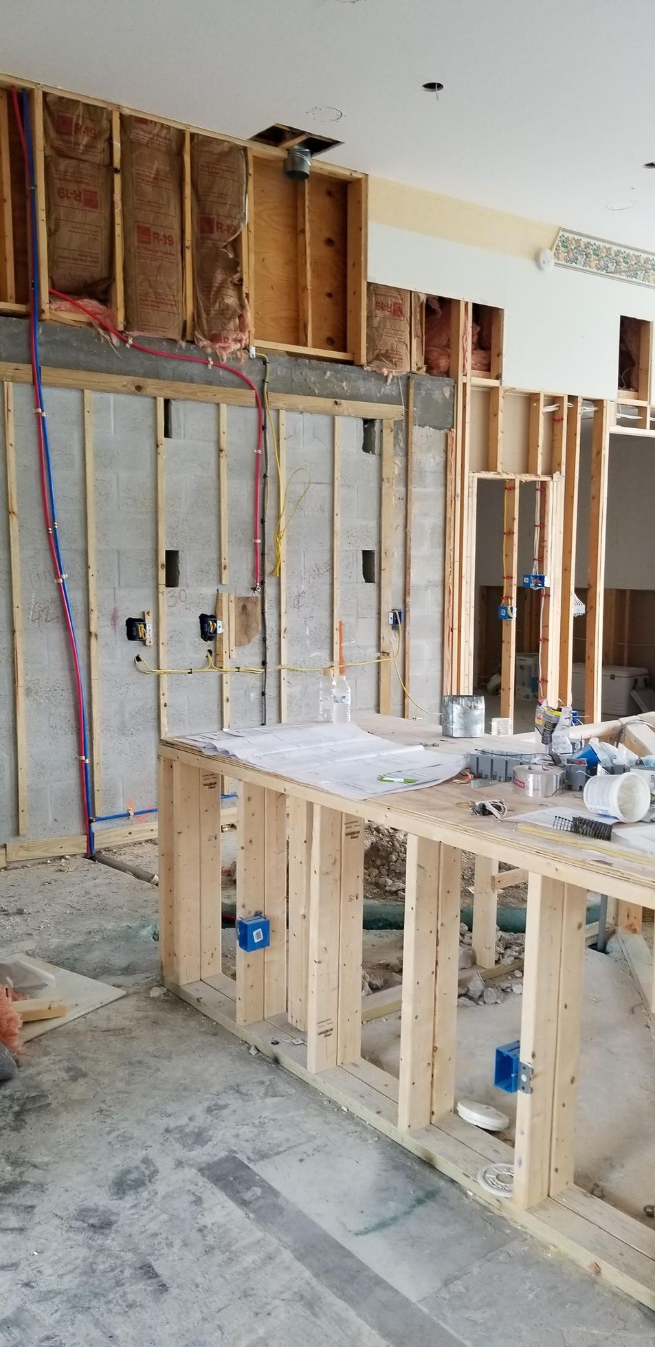 A room under construction with wooden walls and a counter.