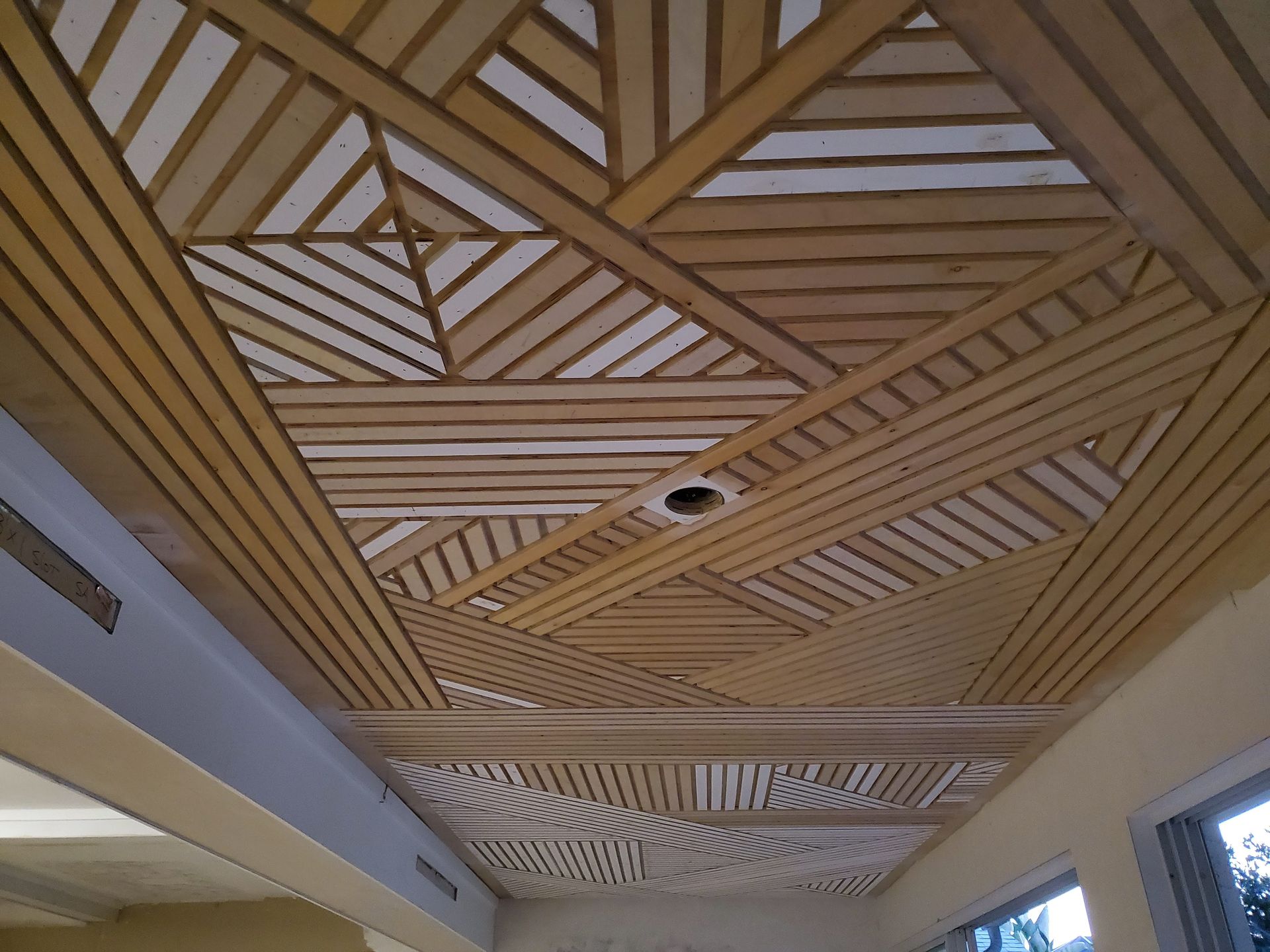 A wooden ceiling with a geometric pattern on it