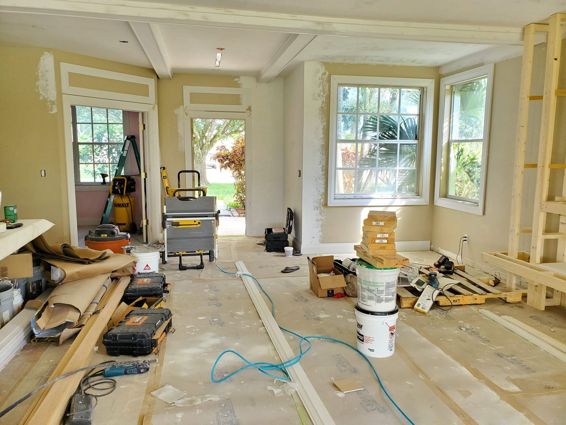 A room that is being remodeled with a lot of tools on the floor.