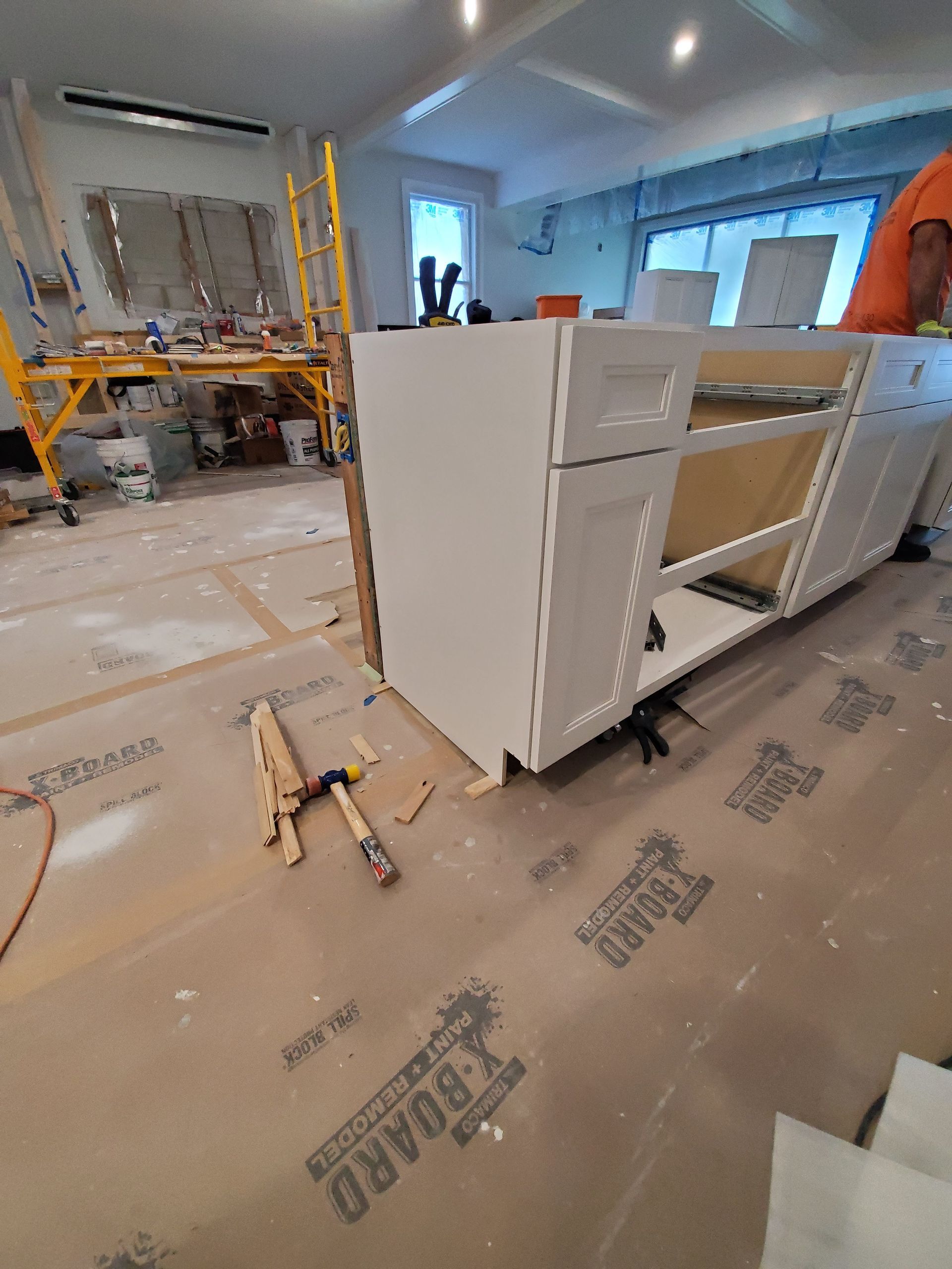 A kitchen cabinet is being built in a room.