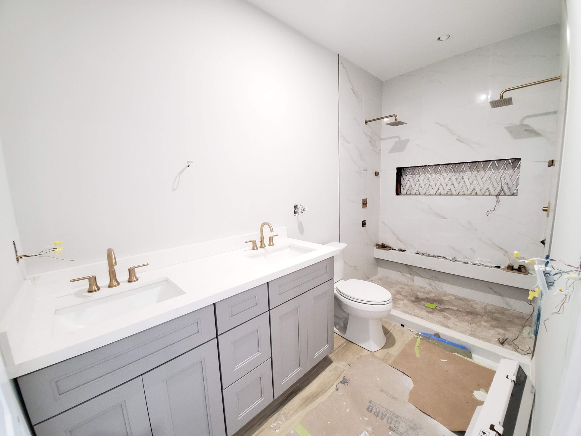 A bathroom with a toilet , sink , and shower.