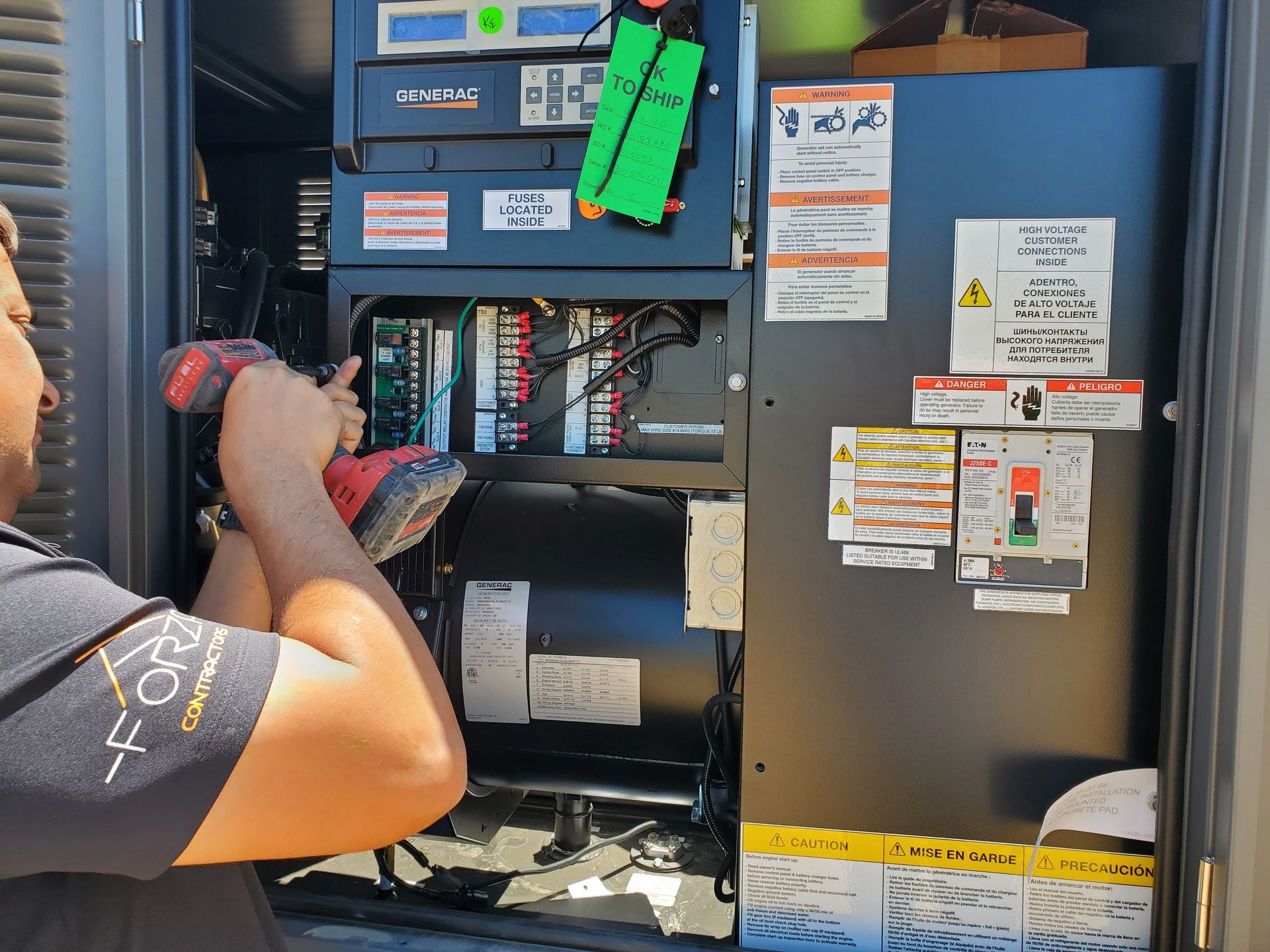 A man is working on a machine with a drill.