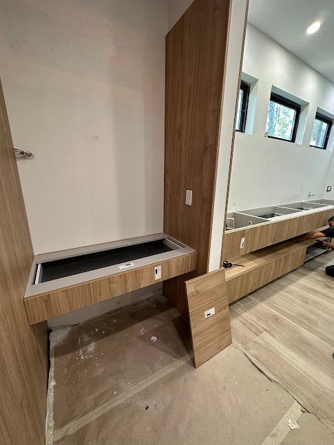A bathroom under construction with a sink and a mirror.