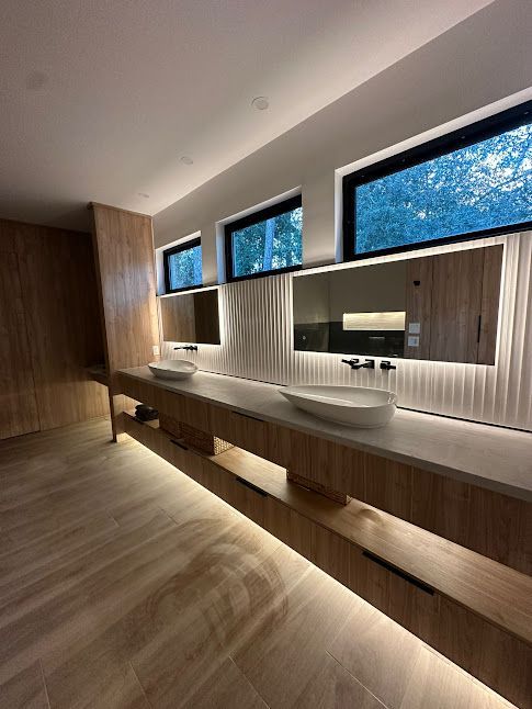 A bathroom with two sinks and two mirrors.