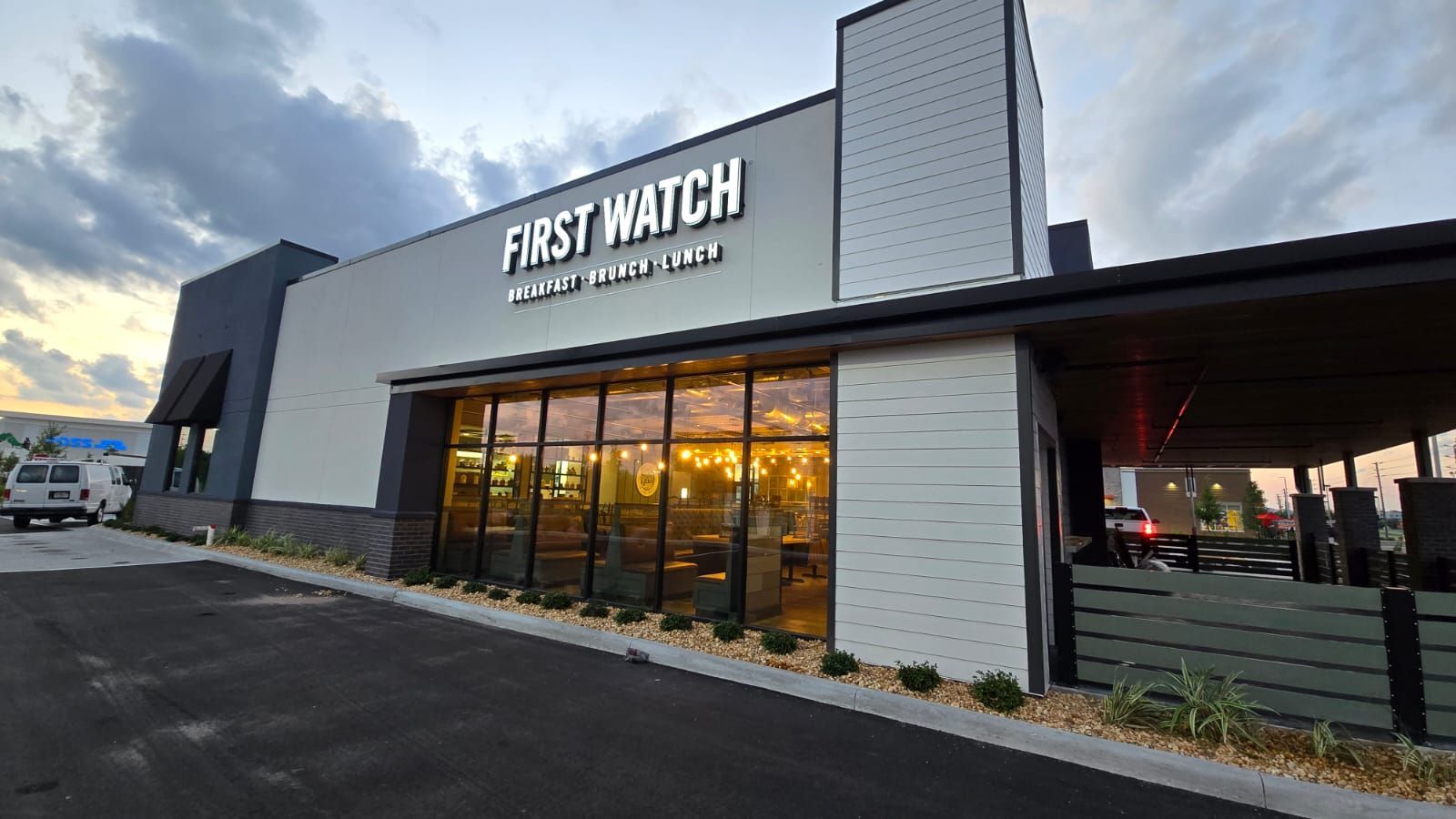 A large building with a lot of windows and a sign that says `` first watch ''.