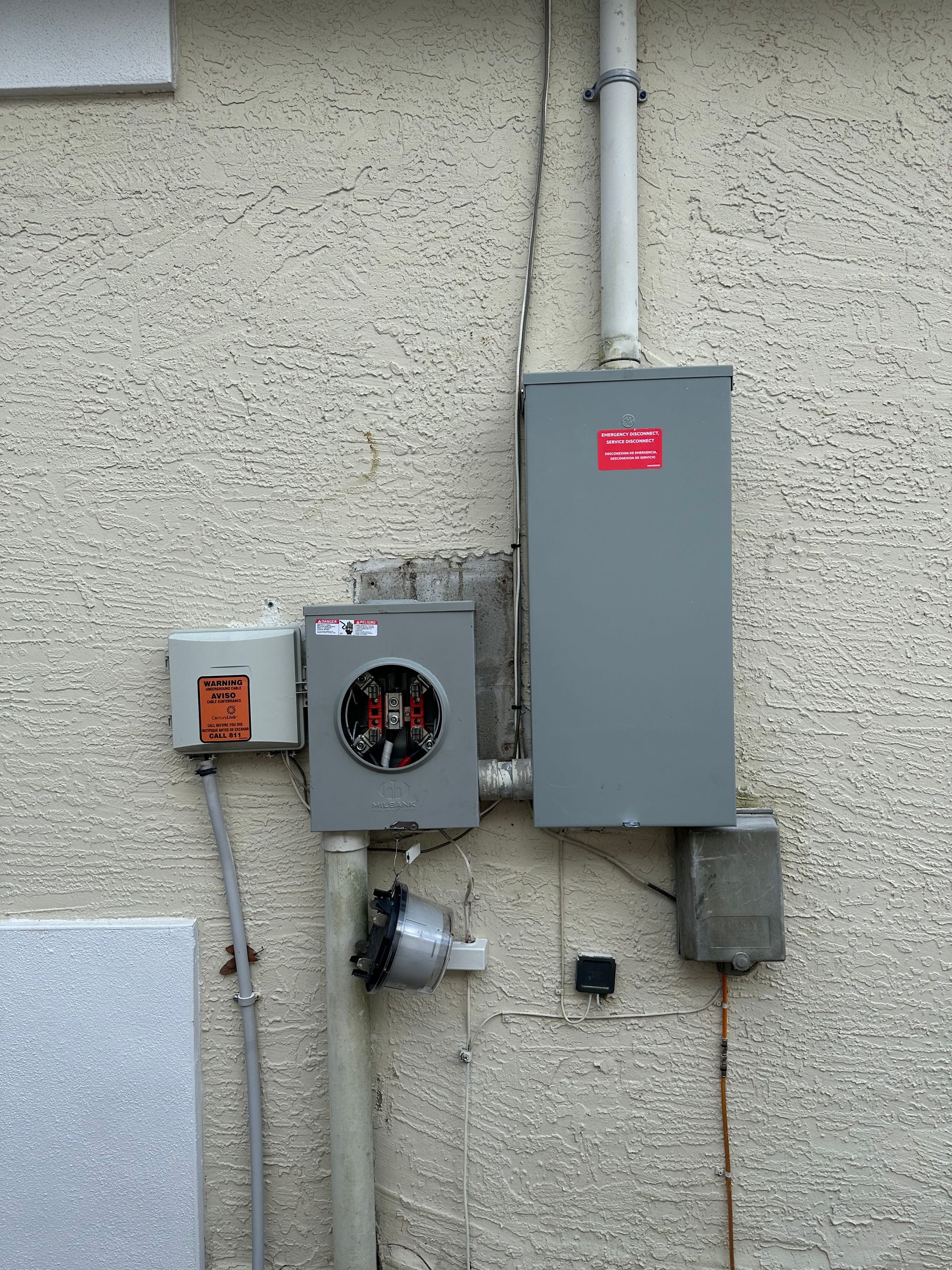 A gray box is attached to the side of a building.