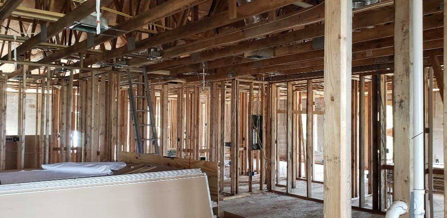 A house is being built with wooden beams and pipes.
