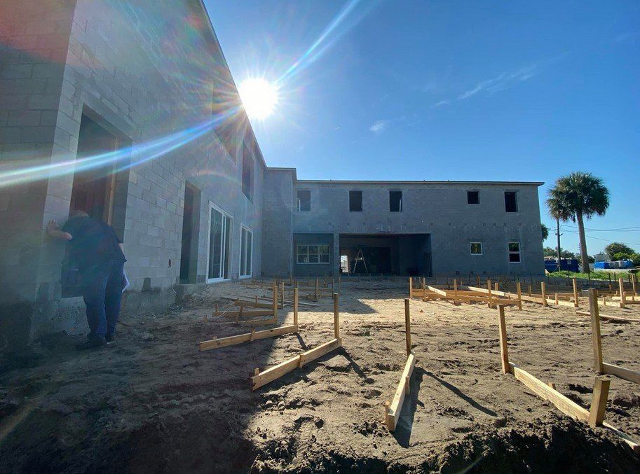 A large building under construction with the sun shining through the windows.