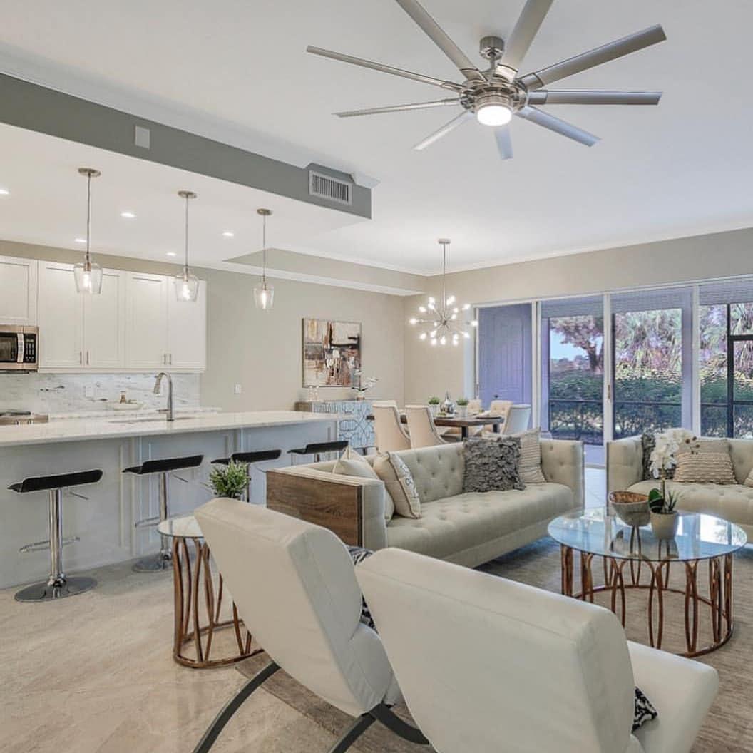 A living room filled with furniture and a ceiling fan.