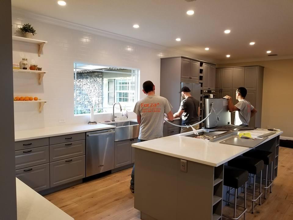 A group of men are working in a kitchen.