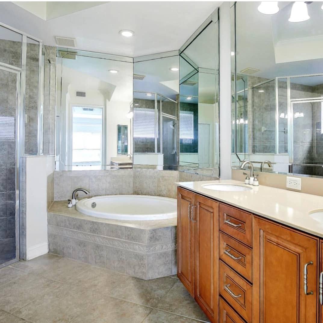 A bathroom with a tub , sink and mirror