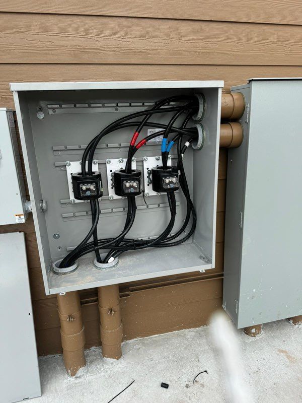 A box with a bunch of wires coming out of it.