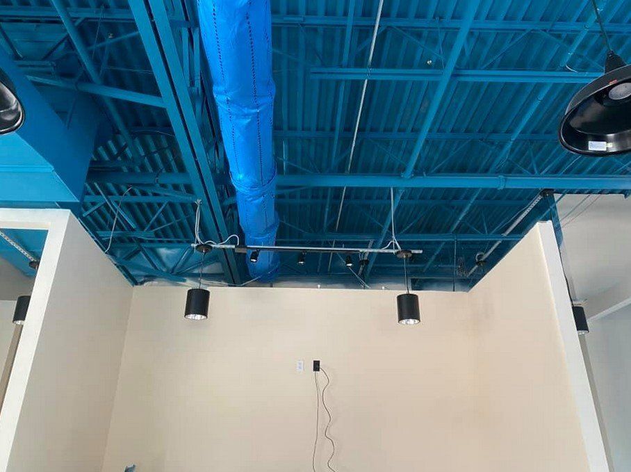 A room with a blue ceiling and white walls
