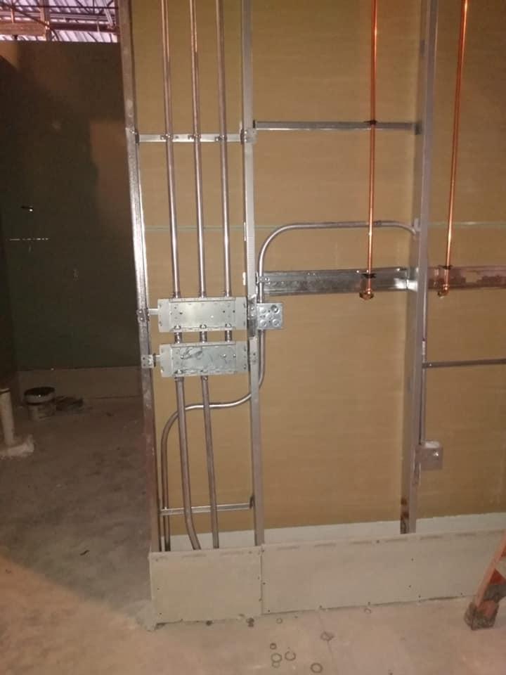 A wall with copper pipes coming out of it