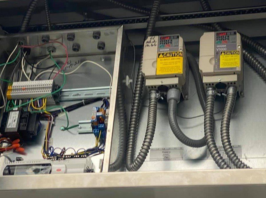 A stainless steel box with a few electrical boxes inside of it