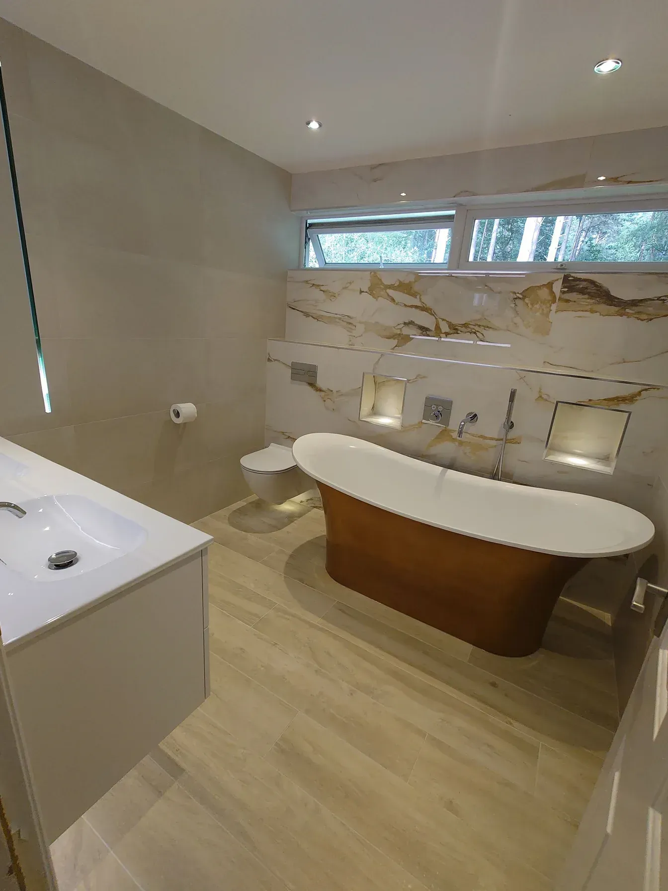 A bathroom renovation featuring a large, free standing bath and stunning large format tiles that were designed, supplied and fitted by Options Bath and Tile Studio Ascot.
