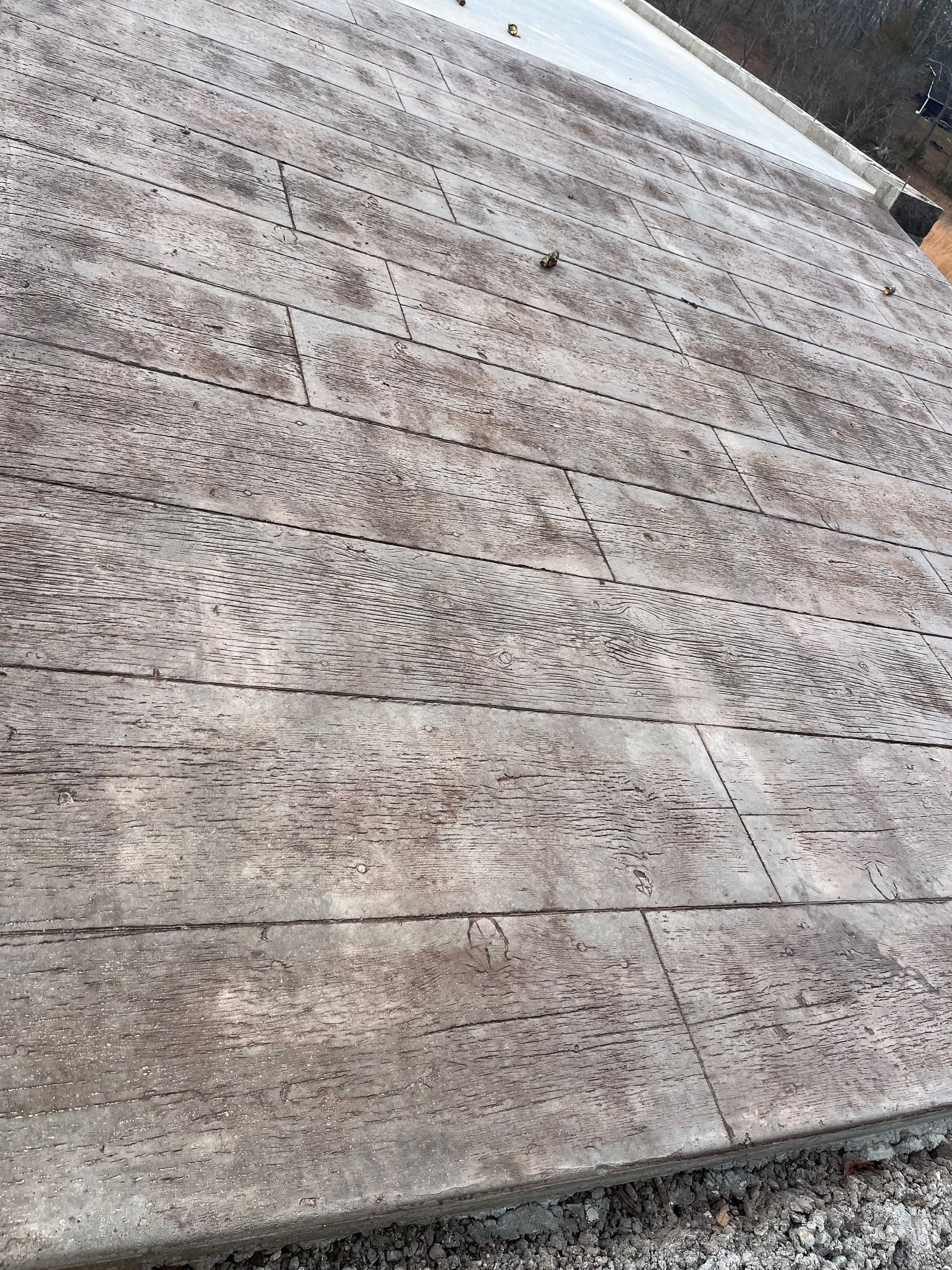 Close-up of a weathered gray wooden surface with horizontal planks and visible grain.