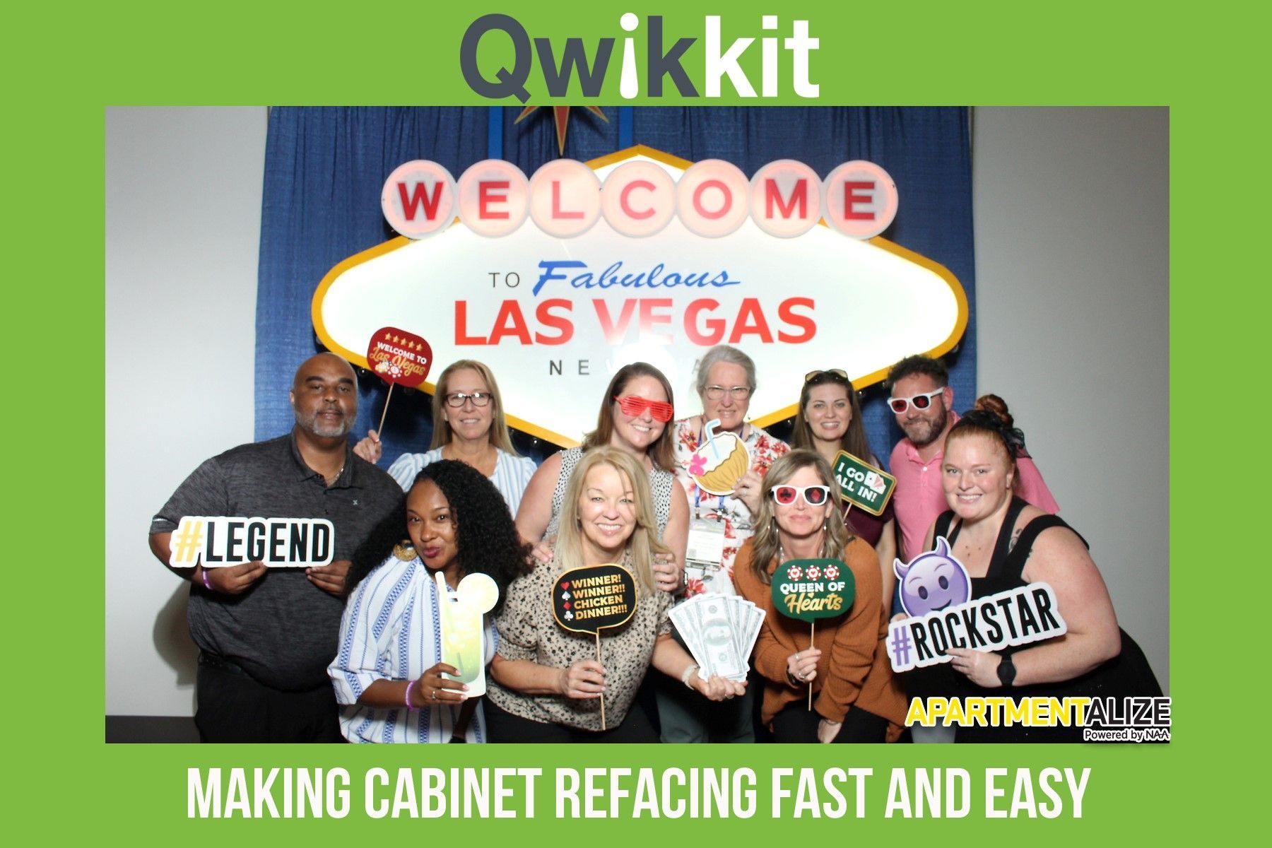 Group of people posing under a “Welcome to Fabulous Las Vegas” sign with Qwikit branding and slogan.