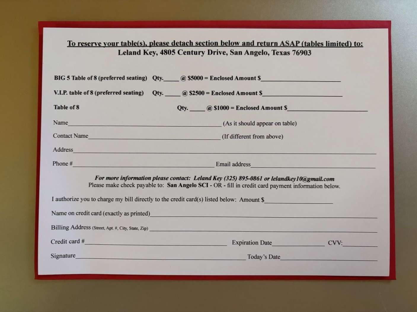 Blurry photo of a printed form on white paper with a red border and multiple blank lines.
