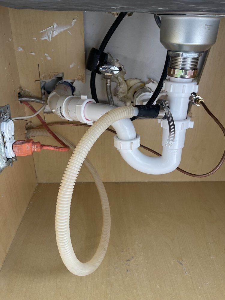 A sink with a hose attached to it underneath it