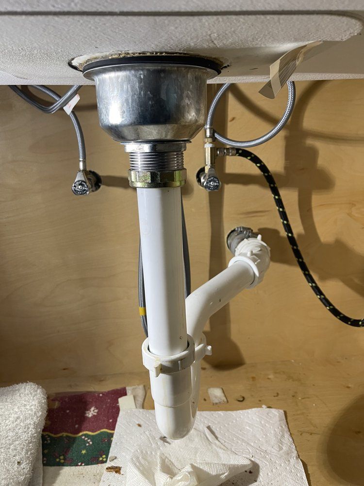 A sink with a drain pipe underneath it
