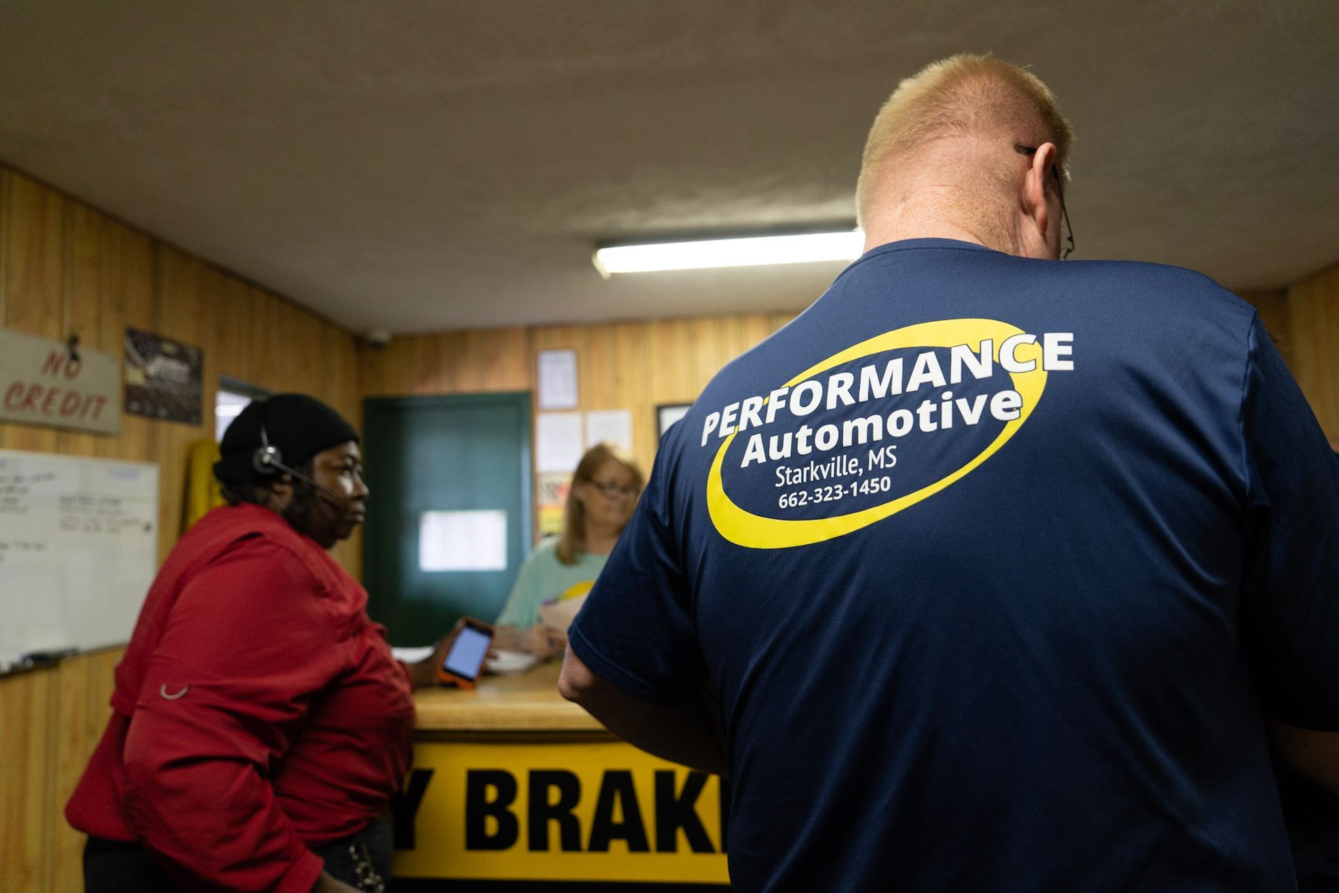 Technician diagnosing transmission under vehicle