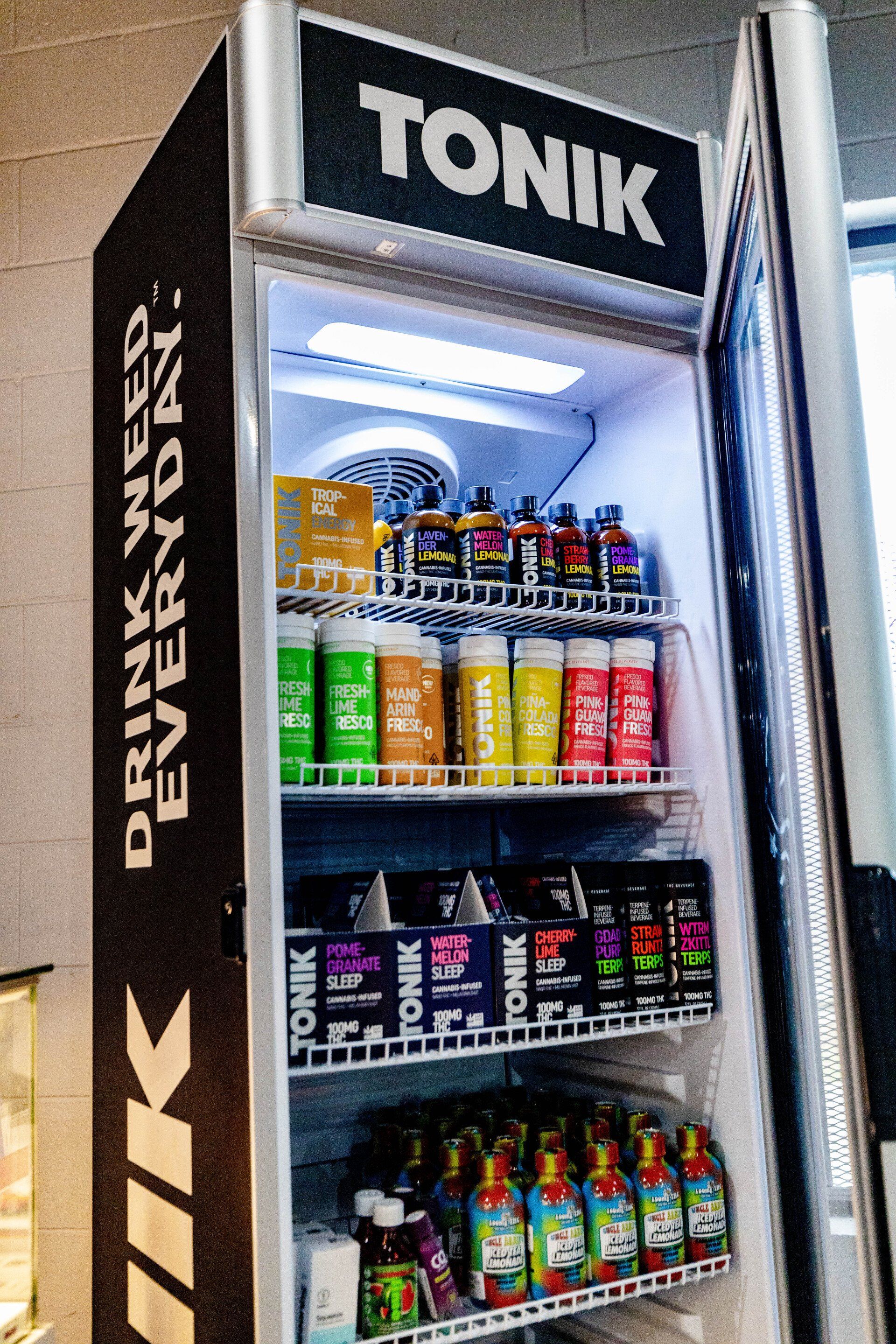 Refrigerated display case stocked with colorful beverages, branded