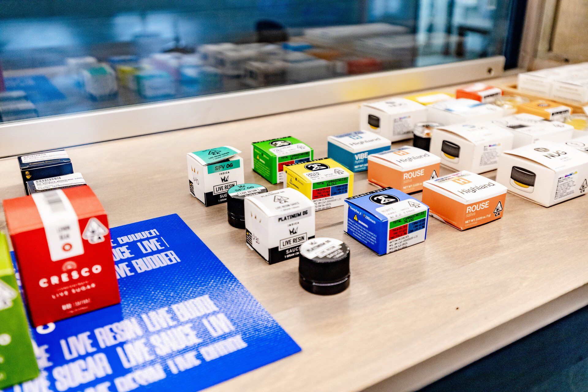 Display case with various colorful cannabis product boxes.