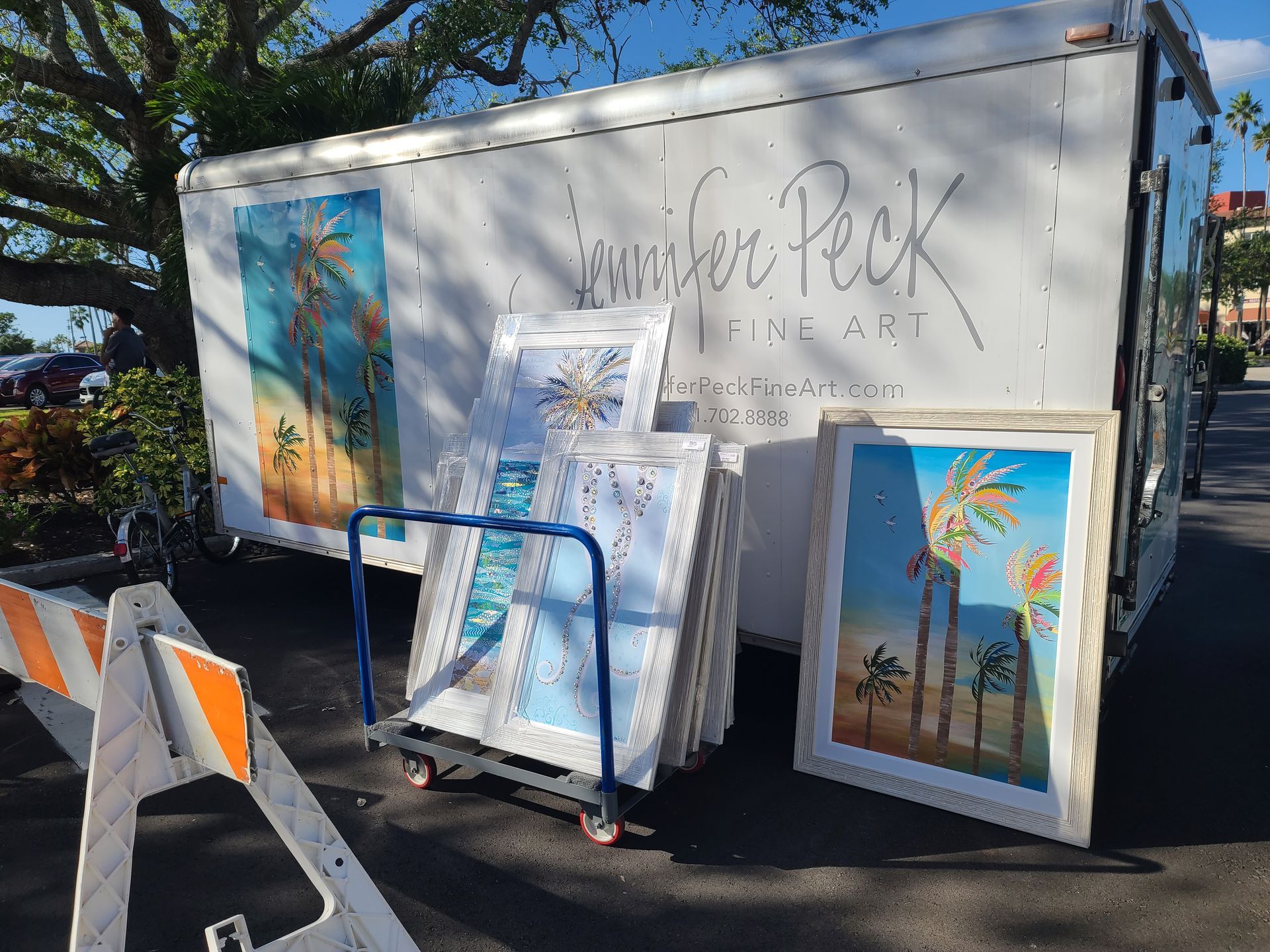 A white trailer with a lot of paintings on it