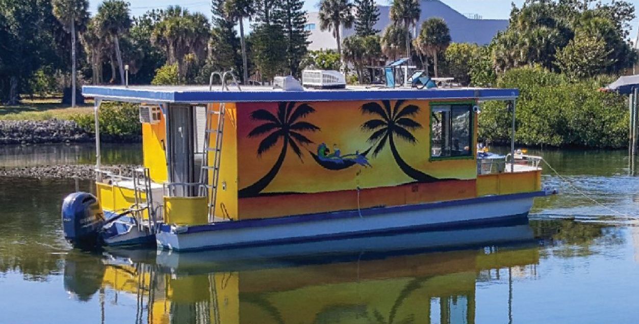 A houseboat with palm tree graphics on the water next to a smaller photo of two people holding paddles by a surfboard.