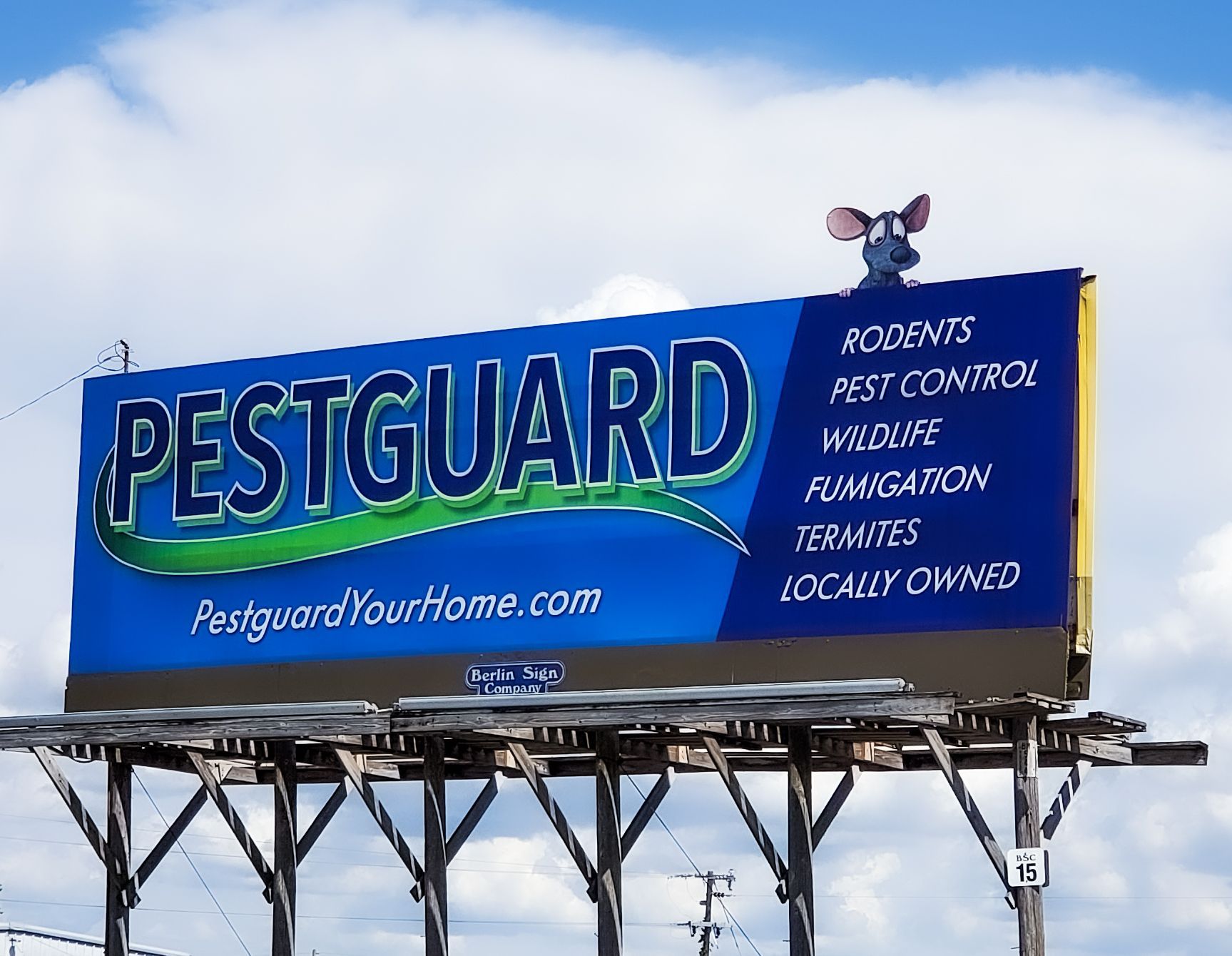 A billboard for pestguard with a mouse on top