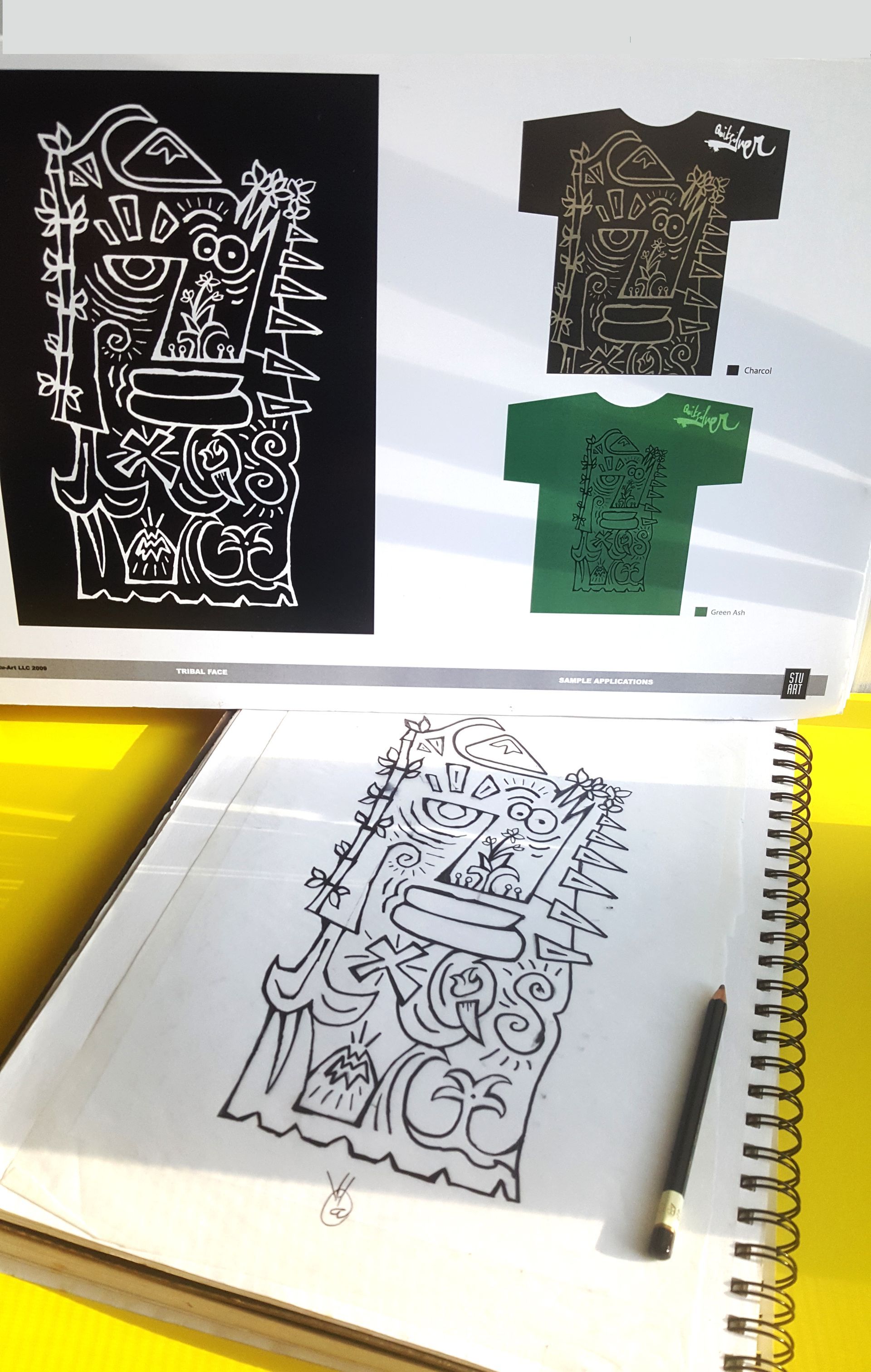 A sketchbook displays a hand-drawn illustration featuring a complex, abstract face, shown
on
T-shirts.