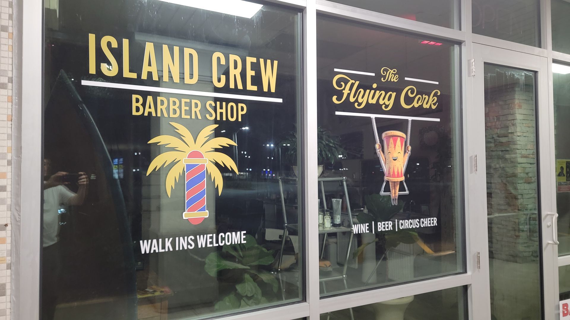 Vinyl cut adhesive signs Window store front signage showing 2 businesses placed on glass using vinyal cut adhesive material