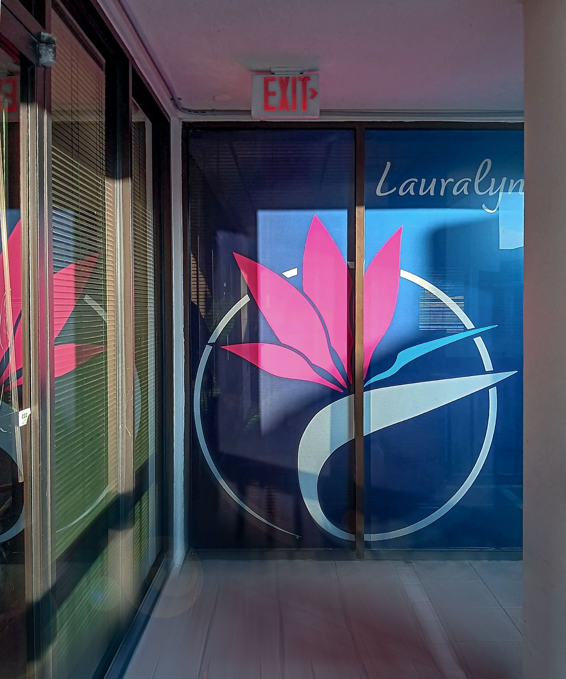 Glass door with logo, pink flower, blue background,
