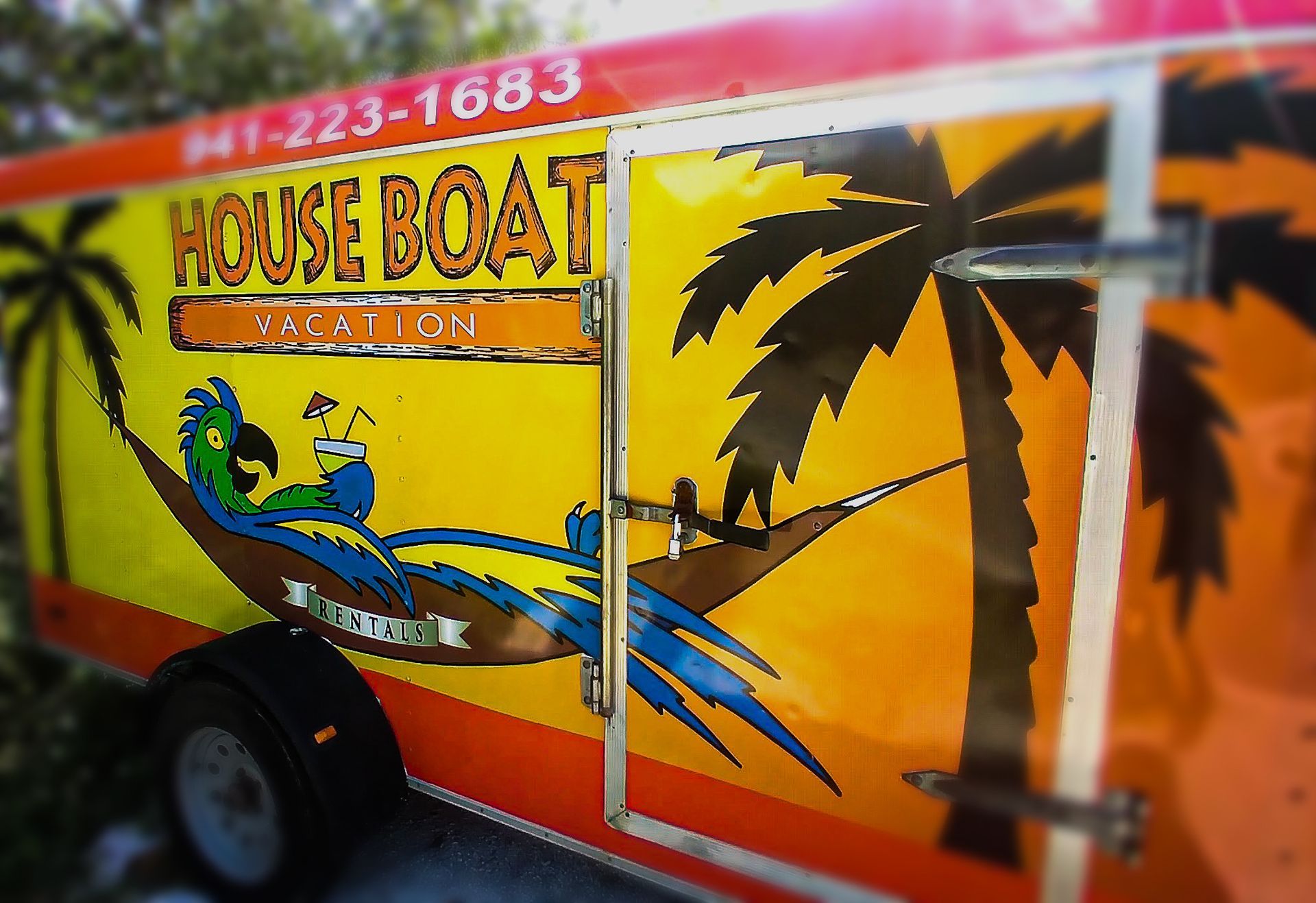 A colorful trailer with the word house boat on it