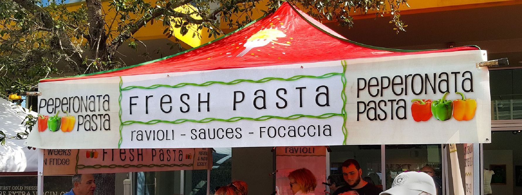 Pasta stand with a red and white awning,