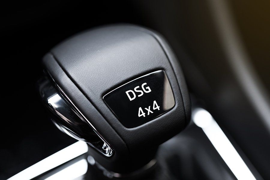 A close up of a car shifter that says dsg 4x4