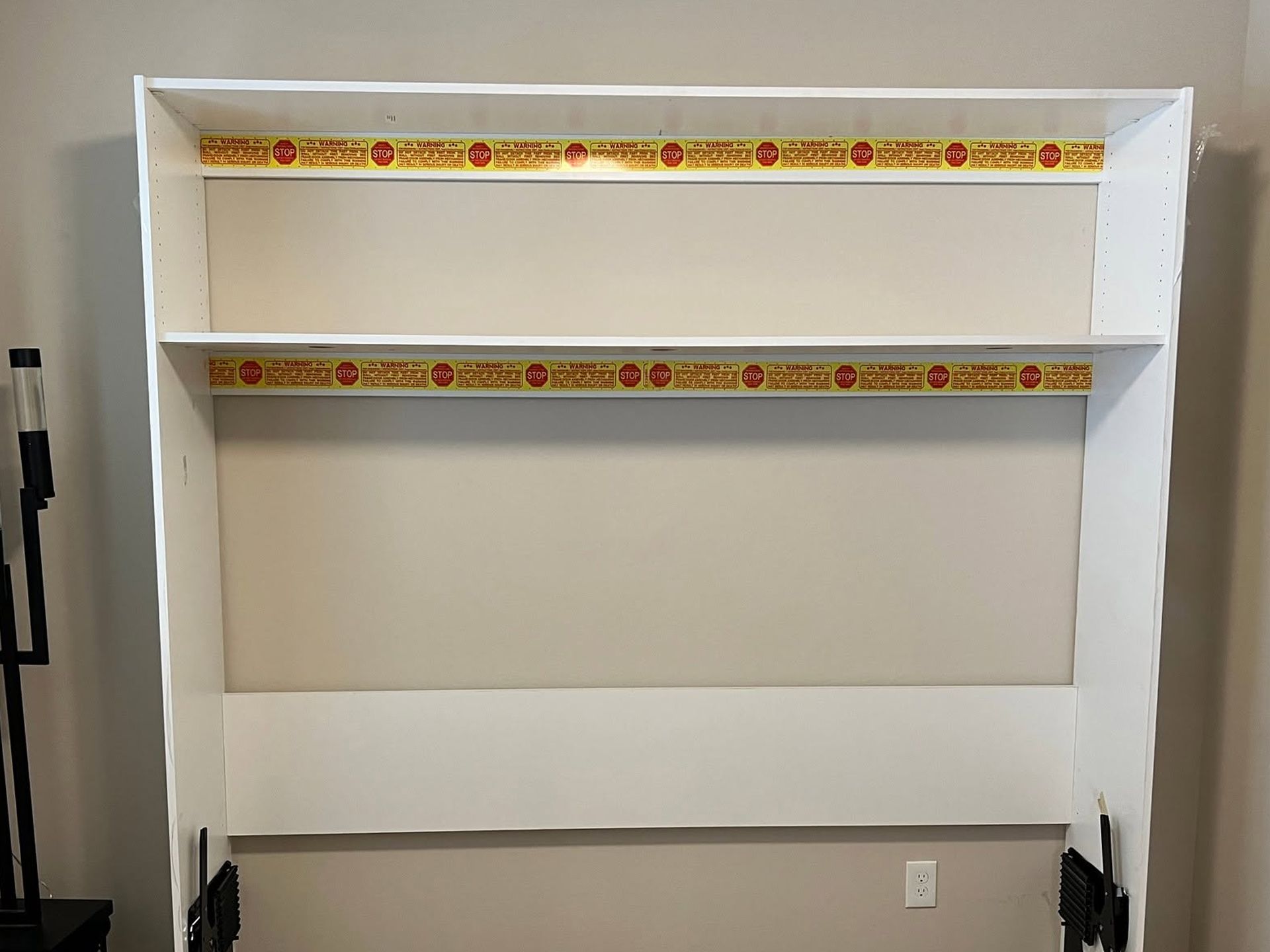 White built-in shelving nook with a decorative border near the top and middle.