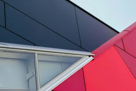 A red and blue building with a white roof