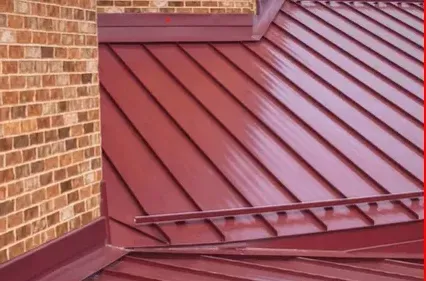 A brick building with a red metal roof