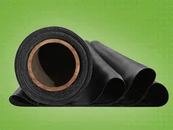 A roll of black rubber sitting on top of a green surface.