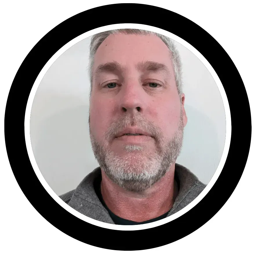A man with a beard is standing in a circle.