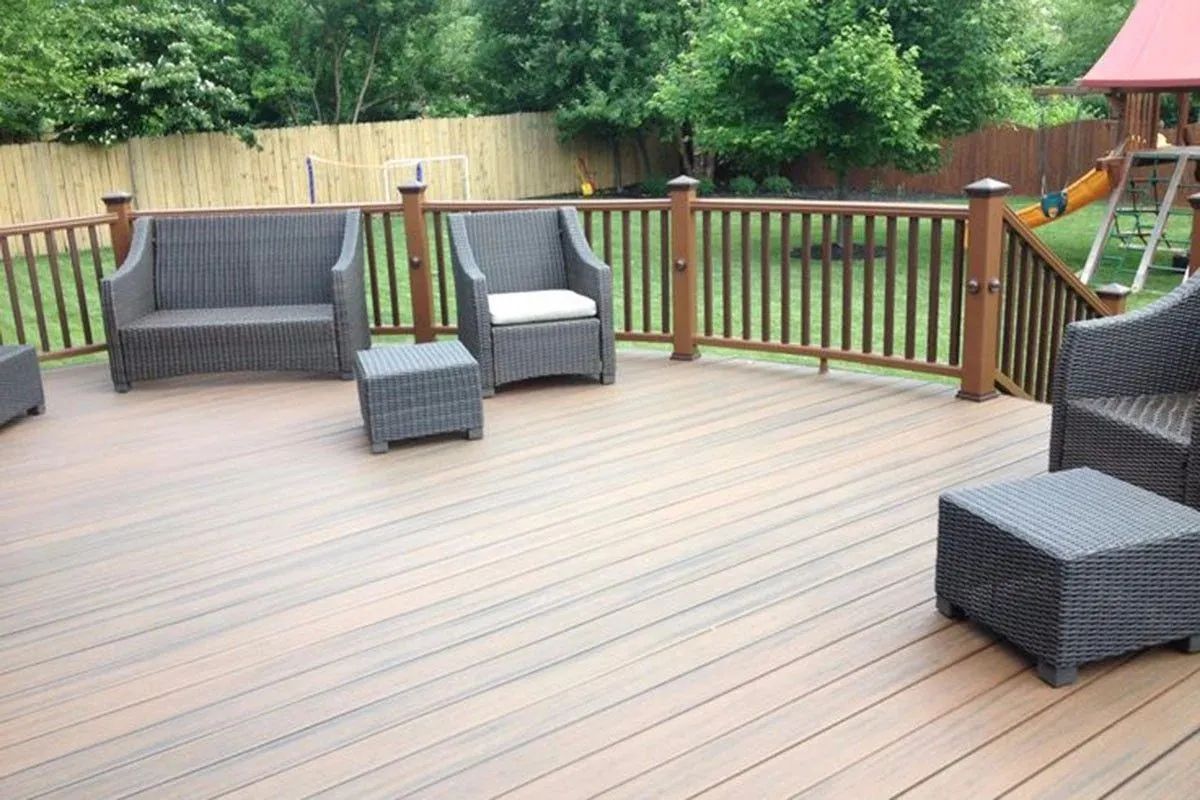 Wooden deck boards secured with black straps over a concrete surface