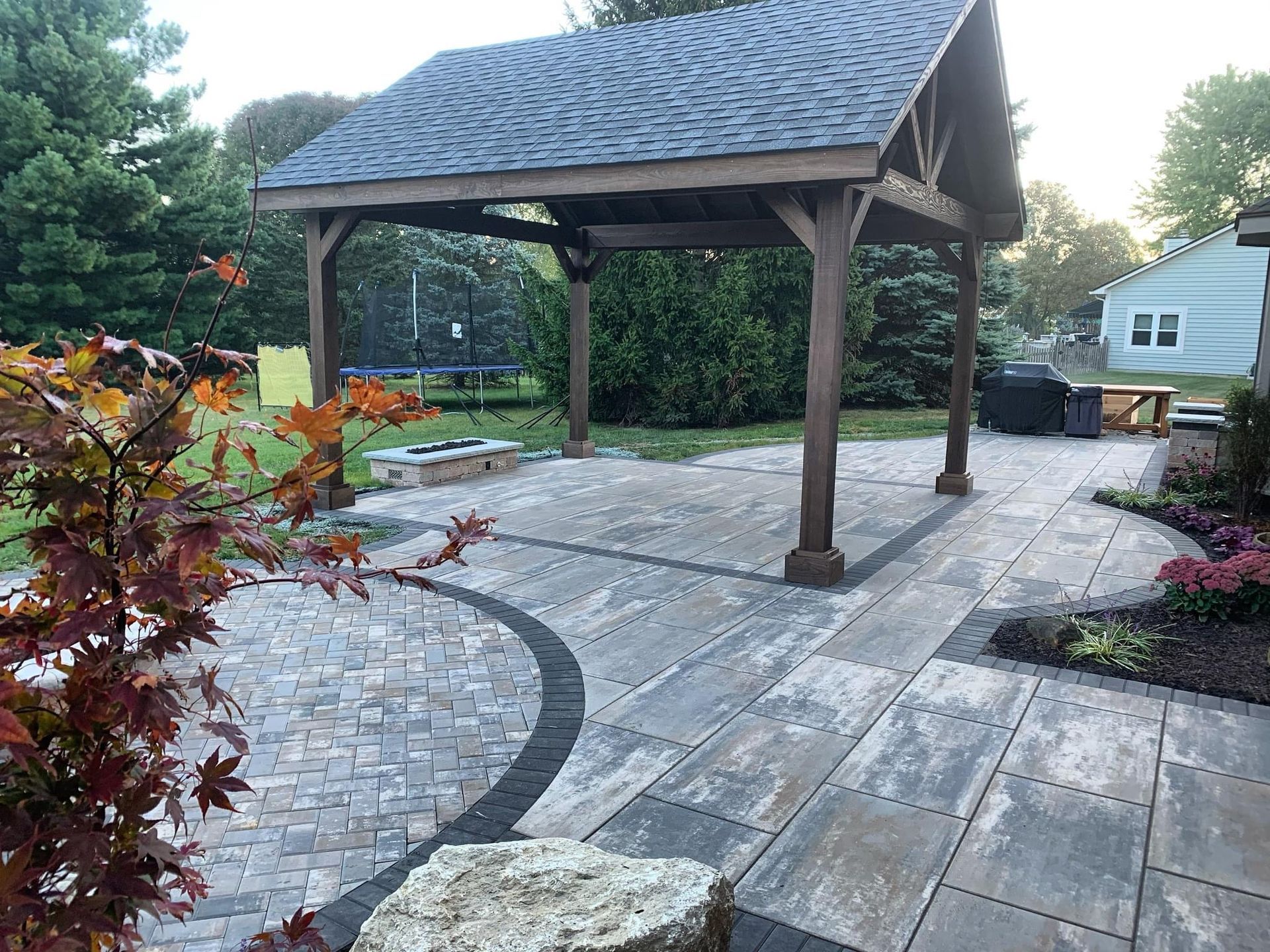 There is a gazebo in the middle of the patio.