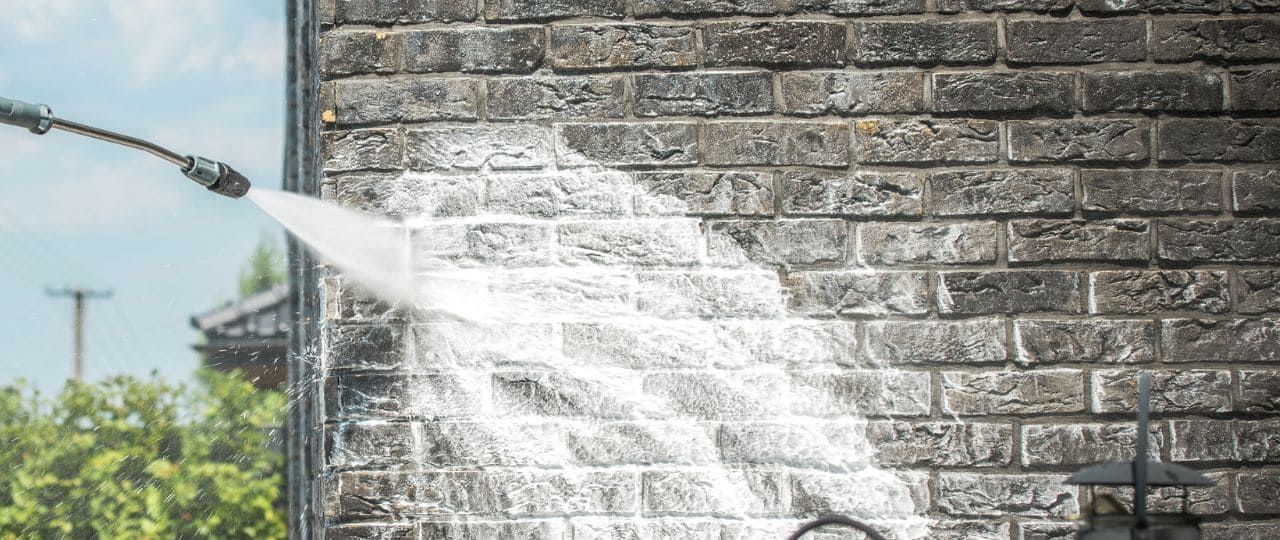 Power washing brick masonry causes surface erosion and increases moisture penetration, contributing to brick spalling and long-term damage.